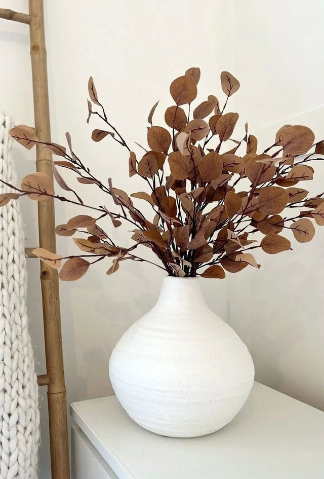 Artificial brown eucalyptus stem from Starlight Express, realistic faux plant with detailed leaves for home decor.