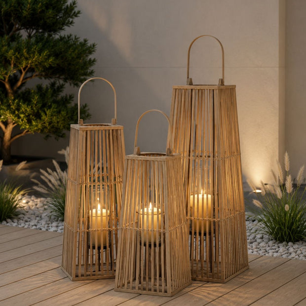 Natural Rattan Wicker Silo Garden Candle Lantern, three tall woven lanterns with candles on a garden deck