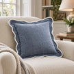 Light blue and white scalloped cushion cover by Starlight Express, soft furnishings for a cozy reading chair.