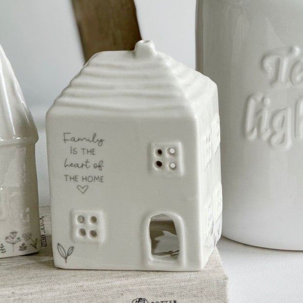 Beige ceramic house-shaped tea light holder from Widdop & Co’s Moments Family home décor collection.