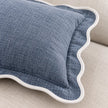 Close-up of a light blue and white scalloped cushion cover by Starlight Express, showcasing soft furnishings with decorative stitching.