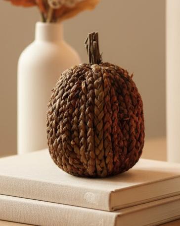 Chocolate Brown Cornhusk Pumpkin, chocolate brown textured pumpkin on books beside a vase