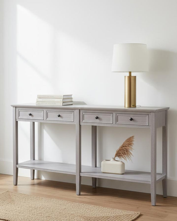 Hill Interiors Serene Collection four-drawer console table with sleek wood finish and modern design, ideal for living room or hallway decor.