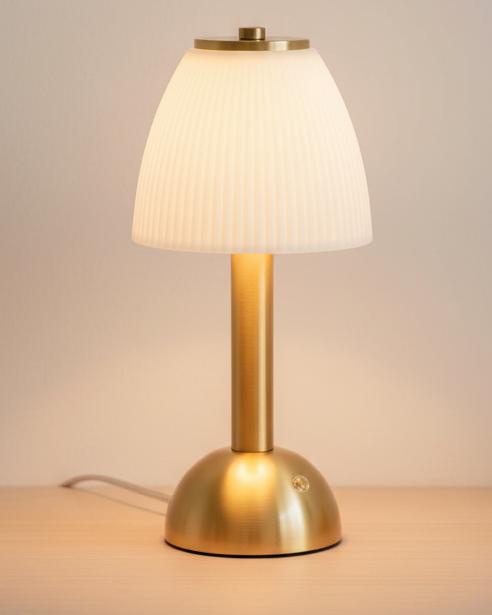 White Ceramic LED Touch Lamp, lit white ribbed-shade lamp with a gold-coloured stem and base