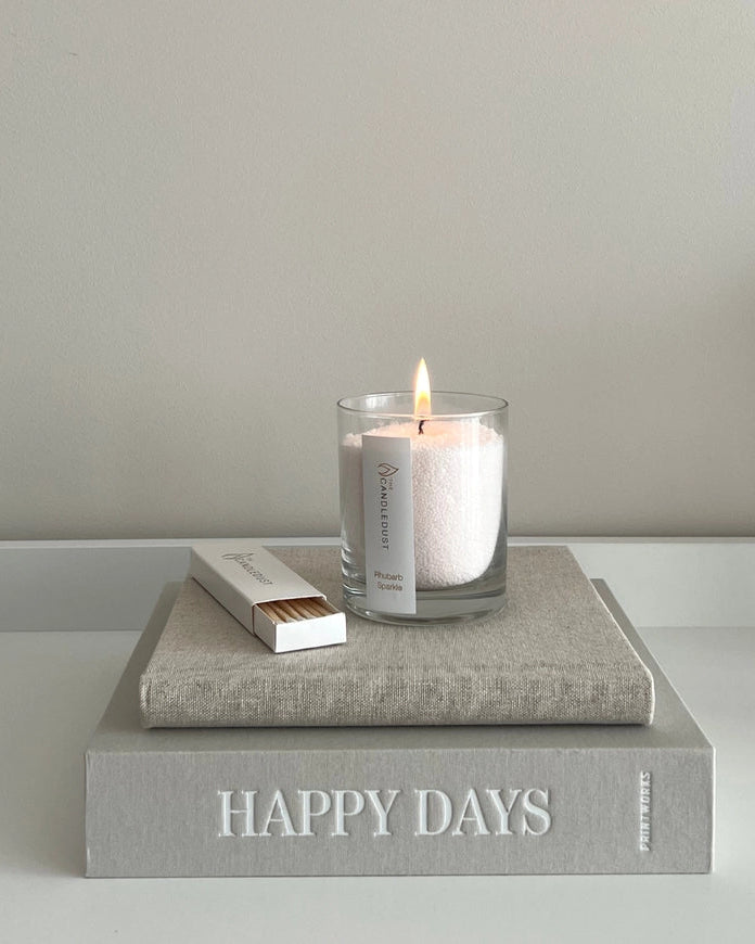 White scented candle in a sand jar with dark honey fragrance, crafted by The Candledust for home fragrance.