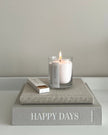 White scented candle in a sand jar with dark honey fragrance, crafted by The Candledust for home fragrance.