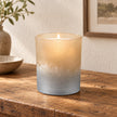 Faded Bronze Glass Tealight Holder, glowing bronze and silver glass holder beside framed artwork