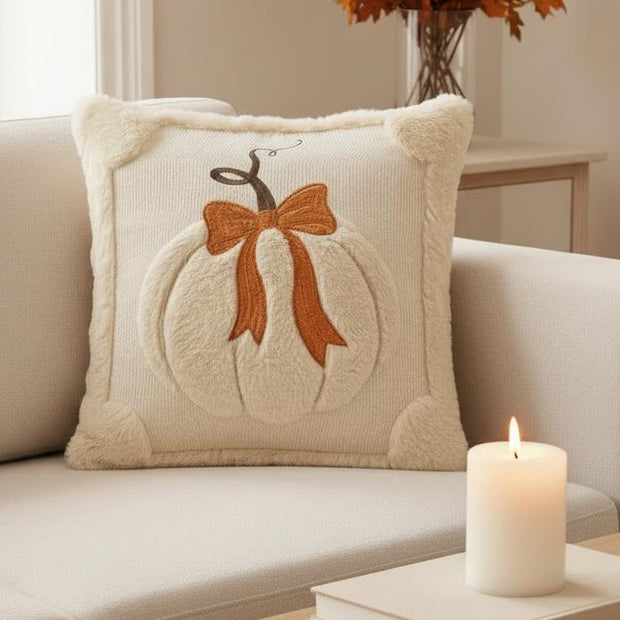 Beige Fluffy Pumpkin With Bow Cushion Cover, beige pumpkin-and-bow cushion beside a lit candle