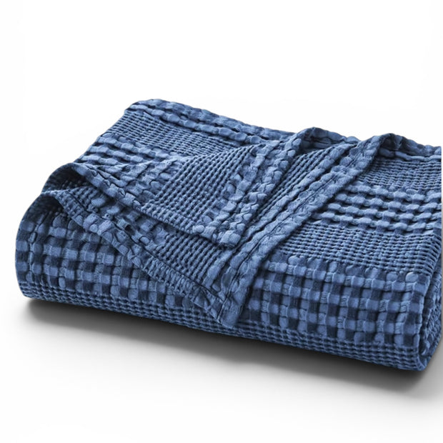 Navy Blue Waffle Throw, folded navy waffle-textured throw against white