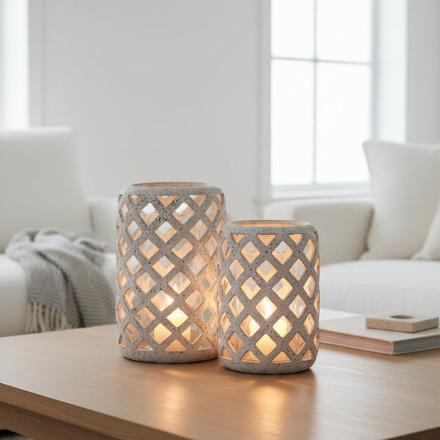 Stone Lattice Hurricane Lantern, two pale lattice lanterns on a coffee table by a window