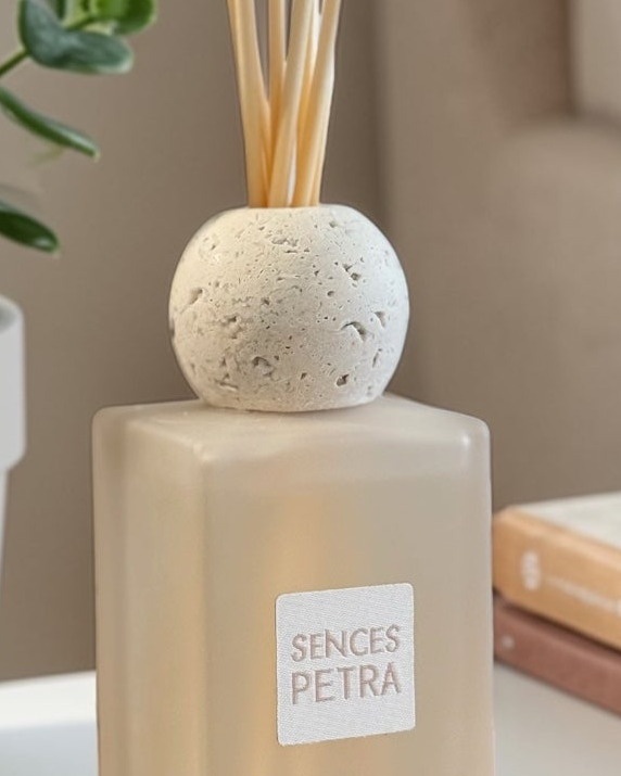 White Petra Reed Diffuser with travertine ball top and pink pepper scent, a stylish home fragrance by Coach House.
