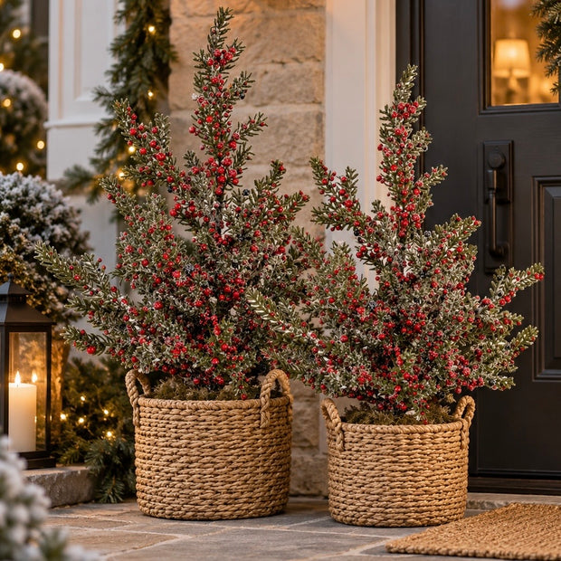 Frosted winter berry Christmas tree on wooden block by Hill Interiors, adorned with snow-like frost and winter berries.