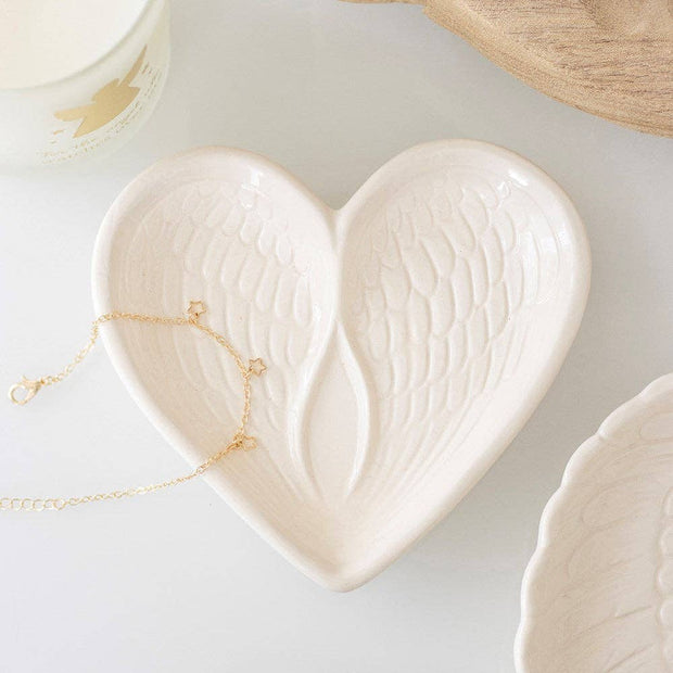White angel wing heart trinket dish with delicate wing and heart design, perfect for jewelry or small keepsakes.