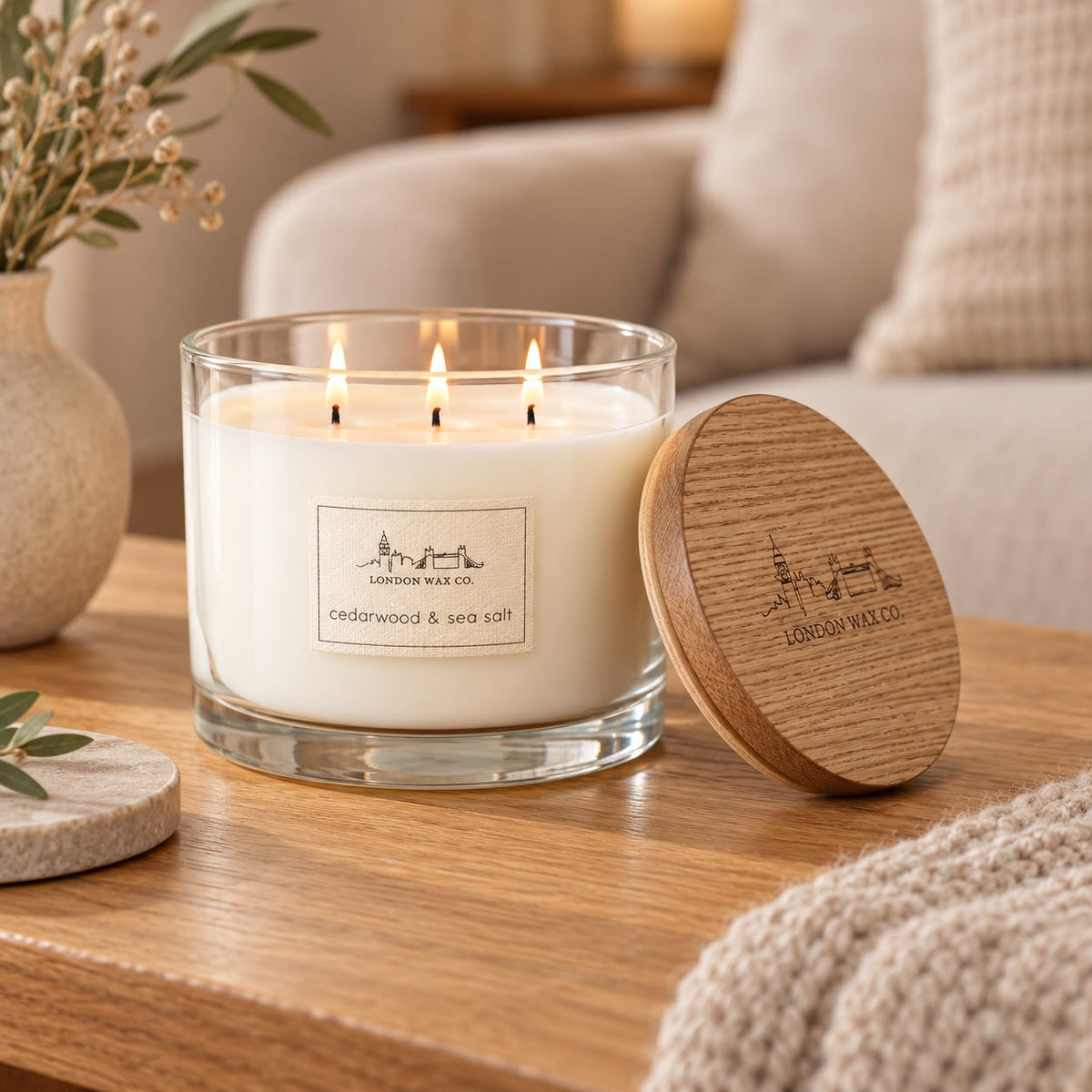 Widdop & Co London Wax Company triple wick cedarwood and sea salt lidded candle with a glass jar and wooden lid.