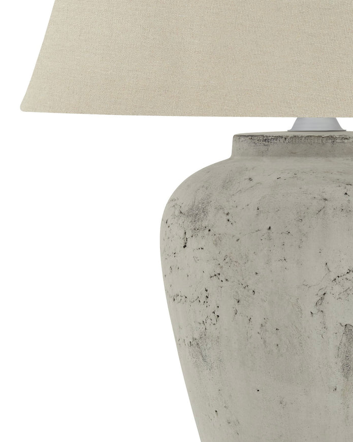 Amesbury medium stone lamp by Hill Interiors, featuring a textured stone base and classic lighting design.