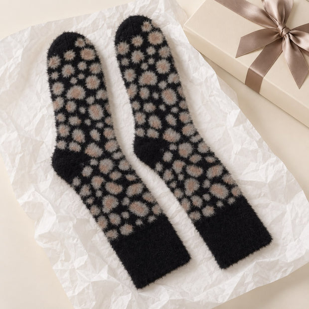 Black Fluffy Leopard Print Socks, black leopard socks beside a wrapped gift