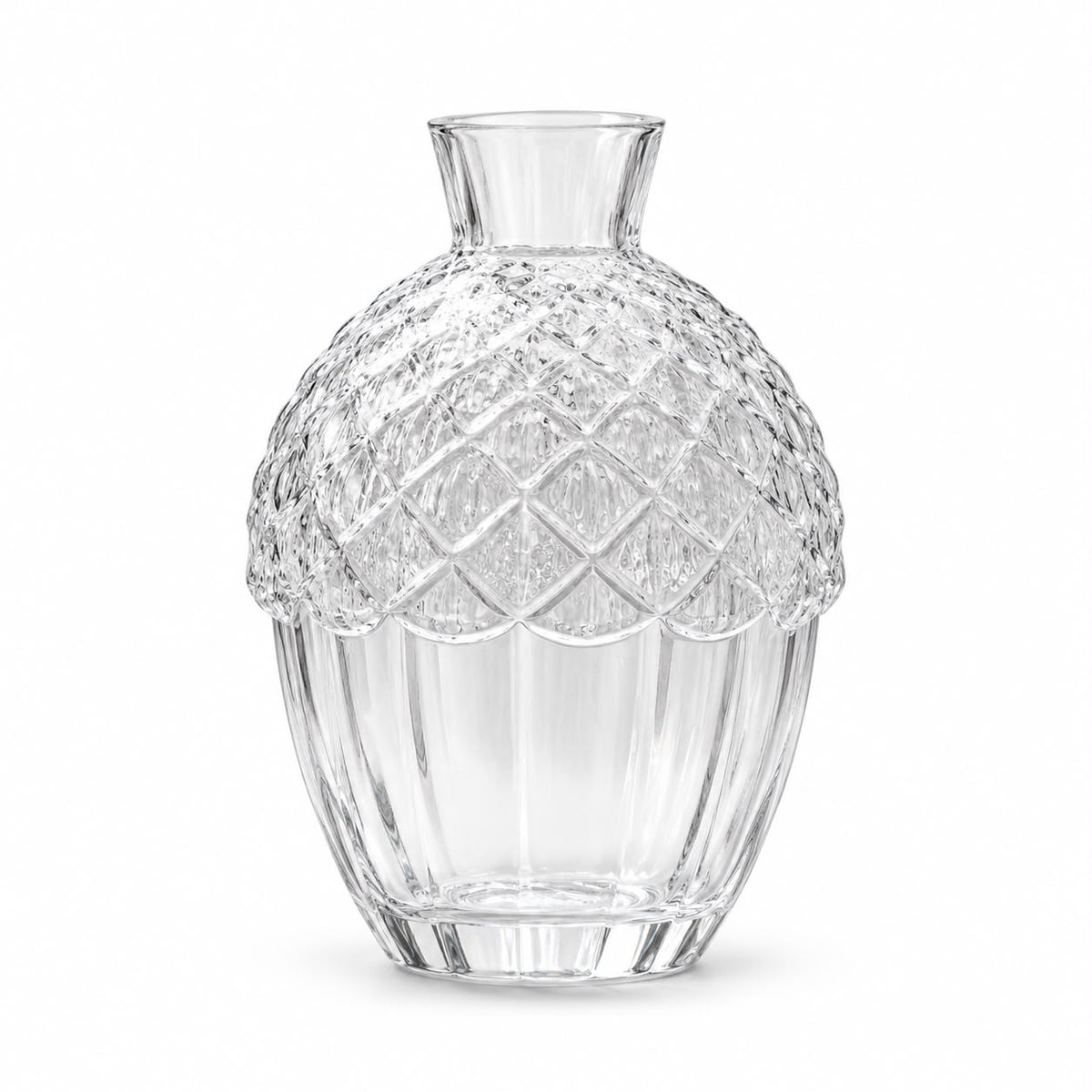 Glass acorn vase with a white flower on a mantel