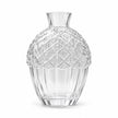 Glass acorn vase with a white flower on a mantel