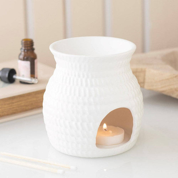 White Basket Effect Oil Burner and Wax Warmer, white basket-textured burner with a lit tealight