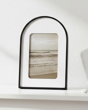 Arched Black And White Photo Frame, black arched photo frame displaying a landscape on a shelf
