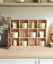 Wooden mug display shelf unit by Starlight Express, ideal for kitchen and dining, showcasing multiple mugs on a rustic wooden rack.