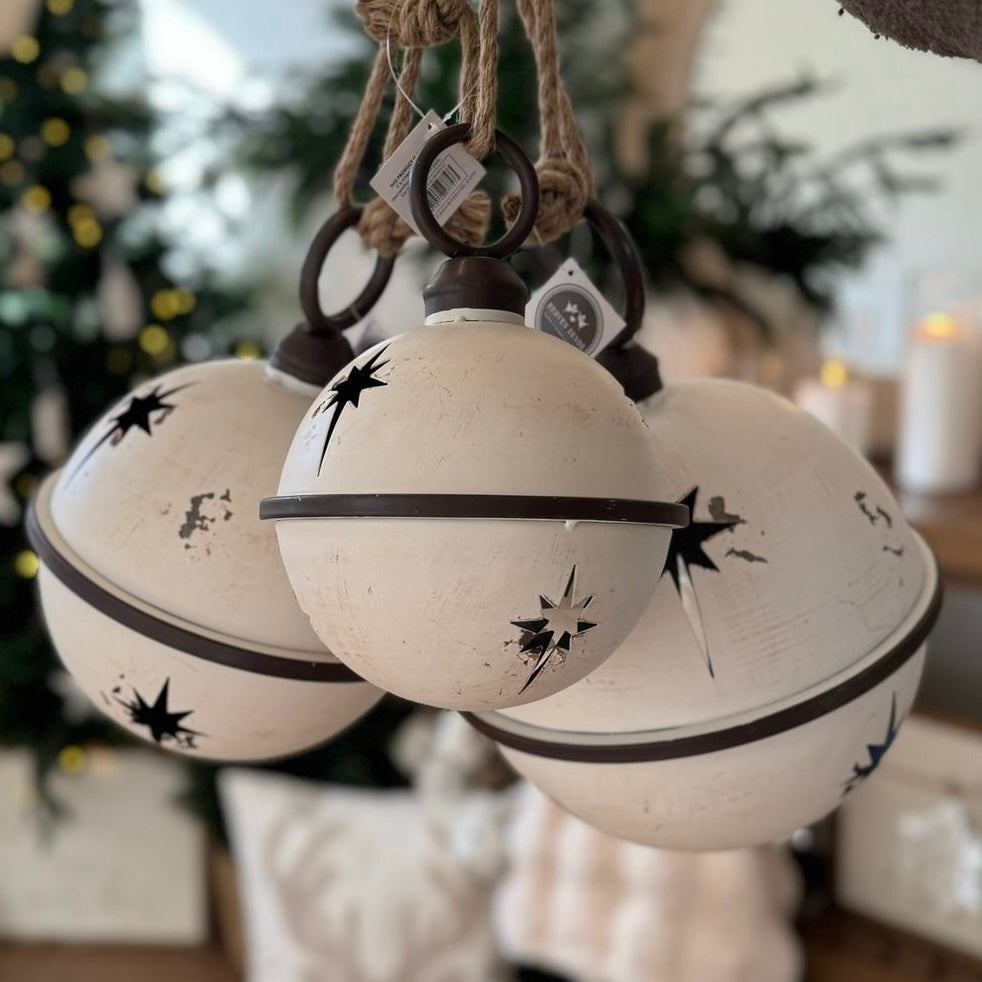 White Round Hanging Metal Bells, three white metal bells hanging outdoors