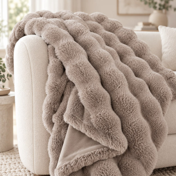 Beige Luxury Faux Fur Blanket Throw, close-up of the beige faux fur throw on a sofa arm