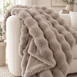 Beige Luxury Faux Fur Blanket Throw, close-up of the beige faux fur throw on a sofa arm