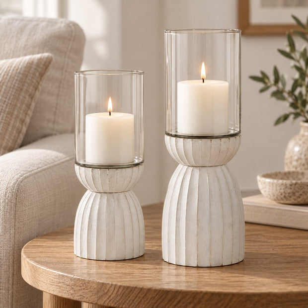 White Carved Hurricane Lantern, two white carved hurricane lanterns on a round wooden table