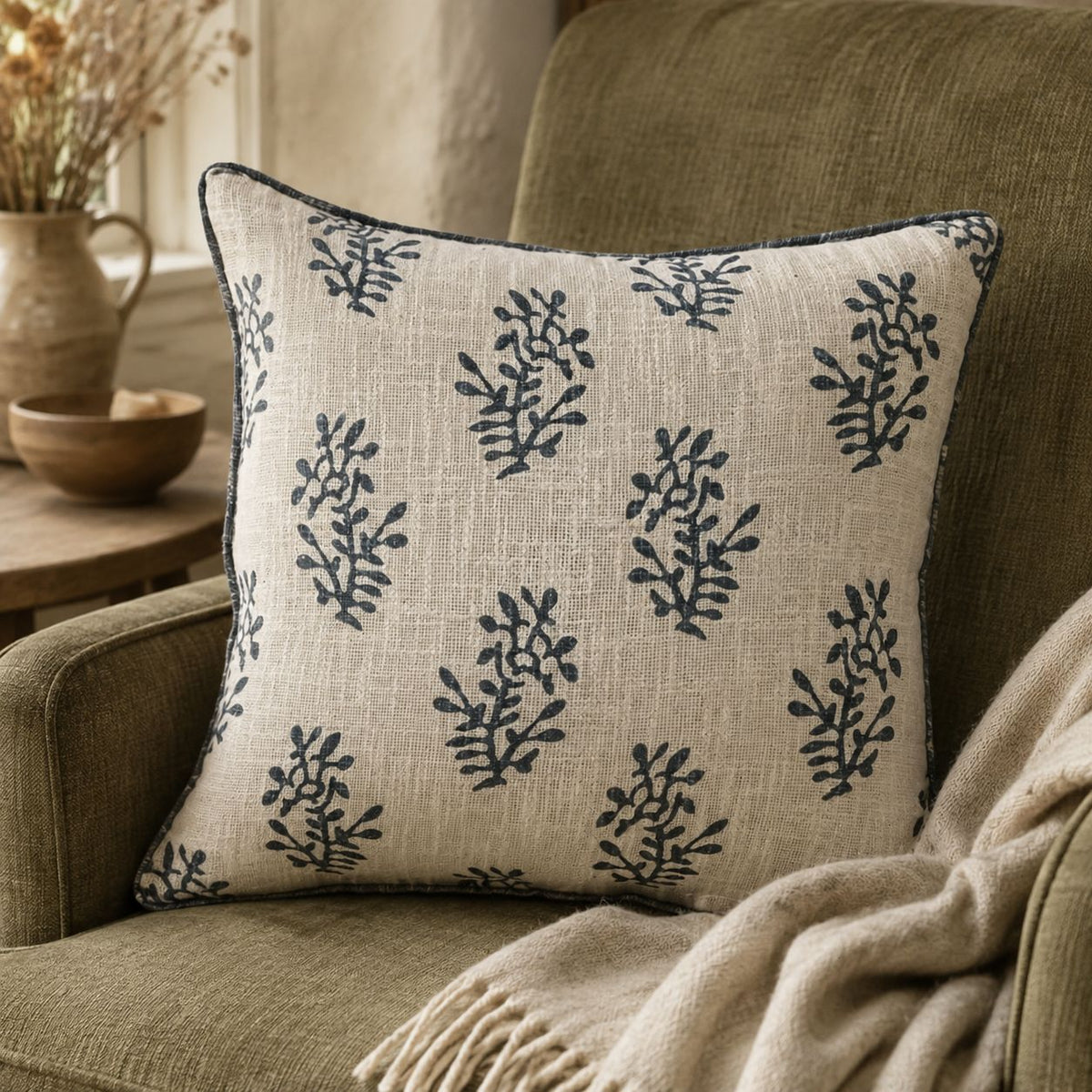Grey Block Printed Reversible Flower Cushion Cover, cream cushion with grey sprigs on a green armchair