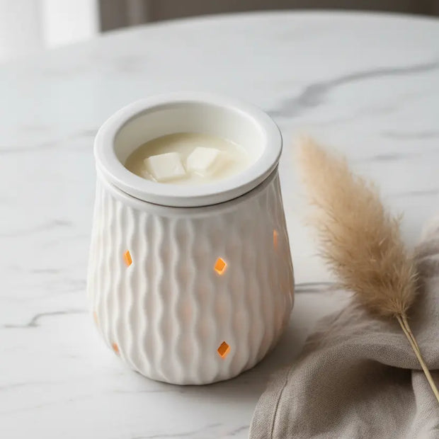 White ripple ceramic electric wax melt burner by Devon Wick, featuring a textured ceramic design and a small dish for wax melts.