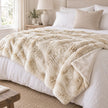 Cream Luxury Faux Fur Blanket Throw, cream faux fur throw spread across a bed
