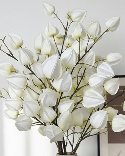 Artificial white lantern stem from Starlight Express, showcasing realistic white lantern-shaped plant with green foliage.