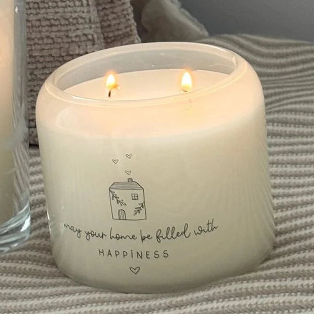 Beige Moments Double Wick Candle - Happy Home, round Happy Home candle burning beside a taller candle