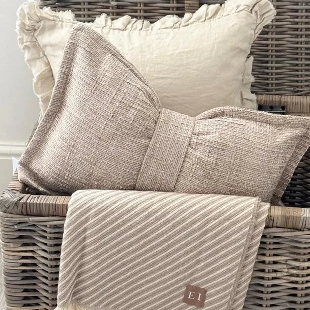 Beige Velveteen Bow Cushion, bow-shaped beige cushion beside cream cushions