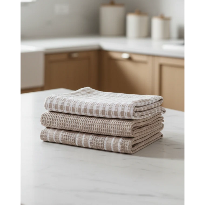 Neutral Cotton Tea Towels - Set of Three, three folded neutral cotton tea towels on a kitchen counter