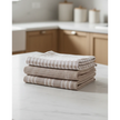 Neutral Cotton Tea Towels - Set of Three, three folded neutral cotton tea towels on a kitchen counter