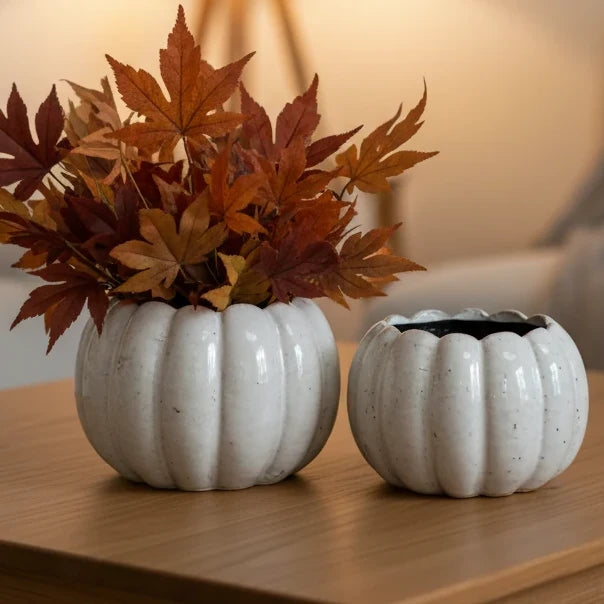 White Ceramic Pumpkin Plant Pot, two white pumpkin planters, one holding autumn leaves