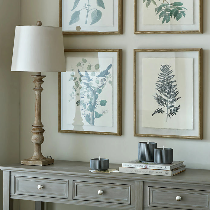 Pallido Candlestick Wooden Lamp, wooden candlestick lamp beneath botanical pictures