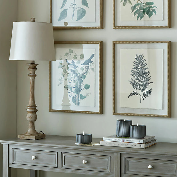 Pallido Candlestick Wooden Lamp, wooden candlestick lamp beneath botanical pictures