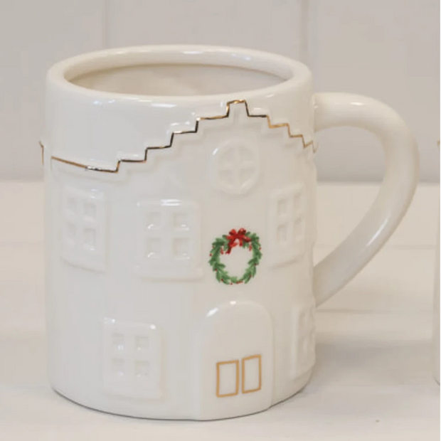 Cosy White Christmas House With Wreath Mug, white Christmas house mug with a small green wreath