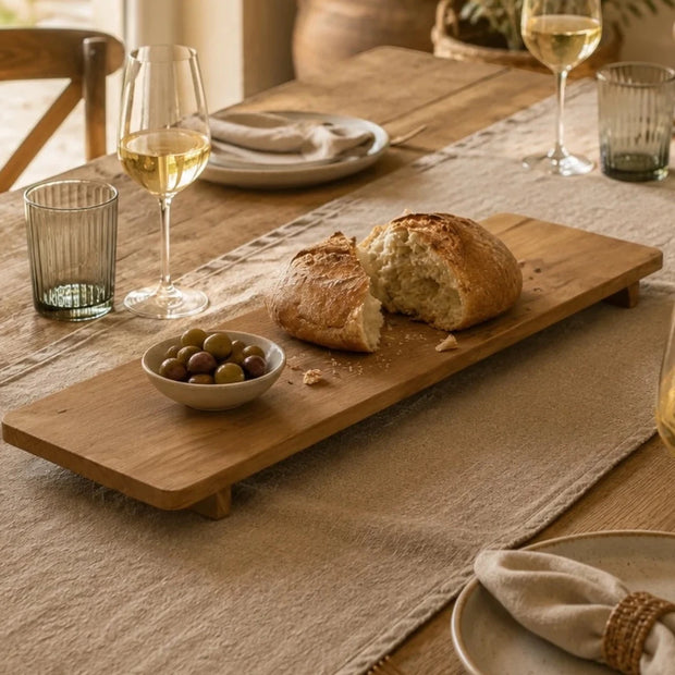 Large Footed Mango Serving Board, rectangular wooden footed board serving bread at a dining table