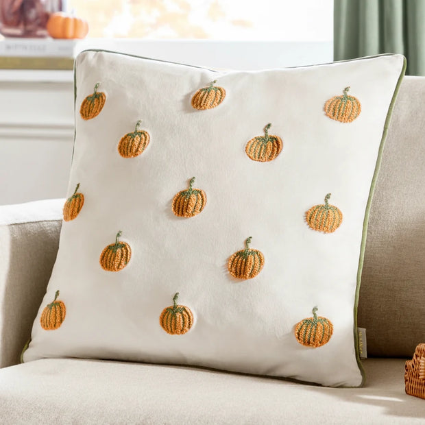 Decorative pillow with pumpkin pattern on a couch