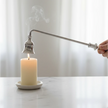 Candle Snuffer - Silver, hand holding a silver snuffer above a smoking candle