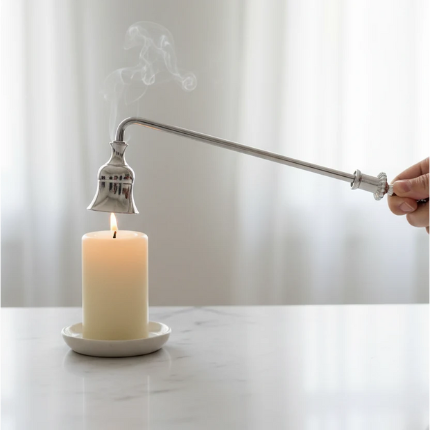 Candle Snuffer - Silver, hand holding a silver snuffer above a smoking candle