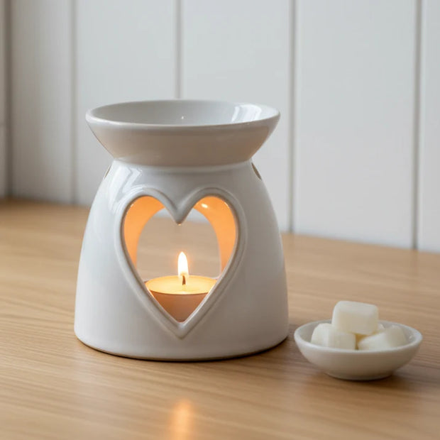 Ceramic Heart Wax Melt Burner, cream heart-cutout wax burner with a lit tealight