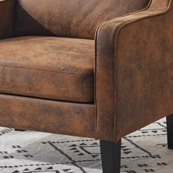 Brown Small Leatherette Tub Arm Chair, close-up of the brown seat cushion and curved arm