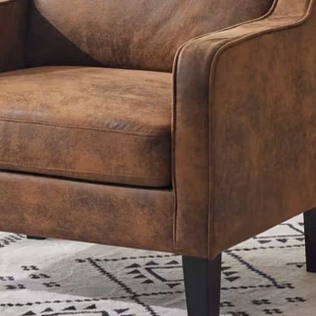 Brown Small Leatherette Tub Arm Chair, close-up of the brown seat cushion and curved arm