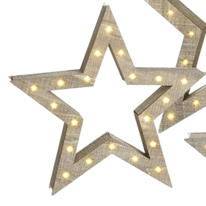 Close-up of natural wooden LED stars showing the wood grain and warm lights around their open frames.