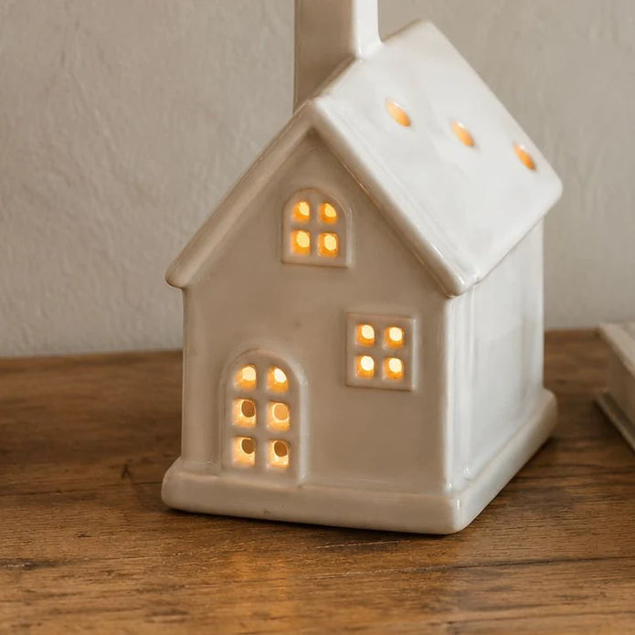 Neutral Ceramic Light Up LED House, glowing cream ceramic house on a wooden table